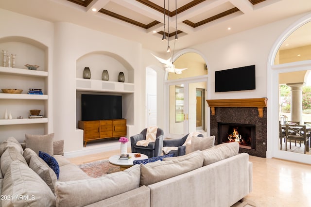 living room with built in shelves, coffered ceiling, and beam ceiling