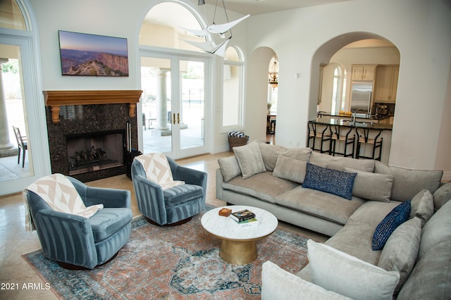 living room featuring a premium fireplace, sink, and light tile patterned floors