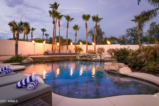 view of pool at dusk