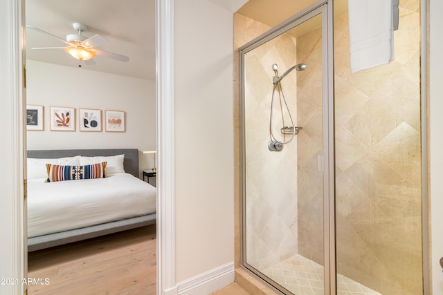 bathroom featuring wood-type flooring, ceiling fan, and walk in shower