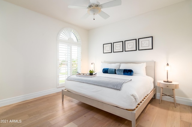 bedroom featuring light hardwood / wood-style flooring and ceiling fan