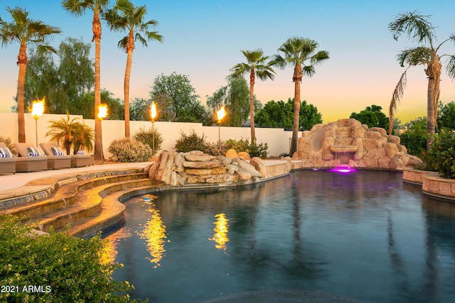 view of pool at dusk