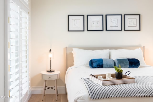 bedroom with hardwood / wood-style floors