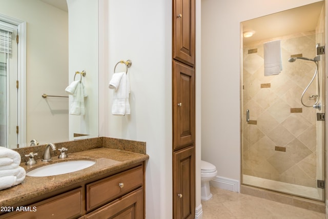 bathroom featuring an enclosed shower, vanity, tile patterned flooring, and toilet