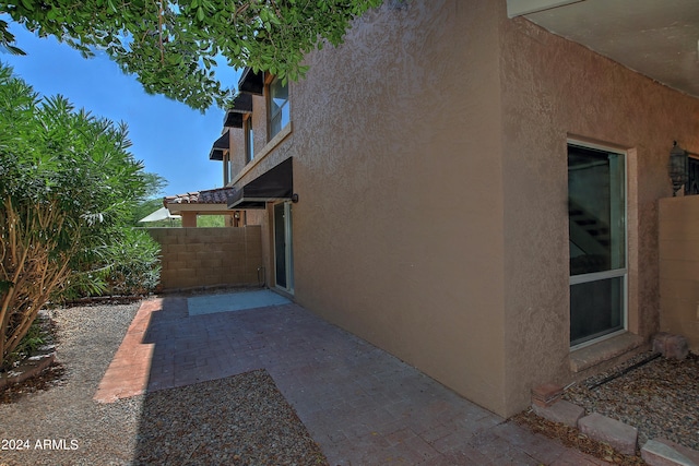 view of side of property featuring a patio area