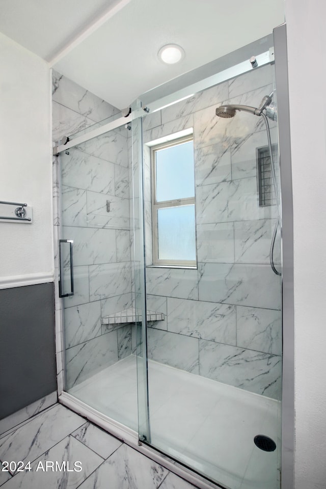 bathroom featuring an enclosed shower and tile patterned floors