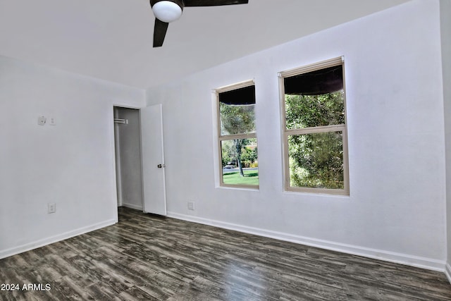 spare room with ceiling fan and dark hardwood / wood-style floors