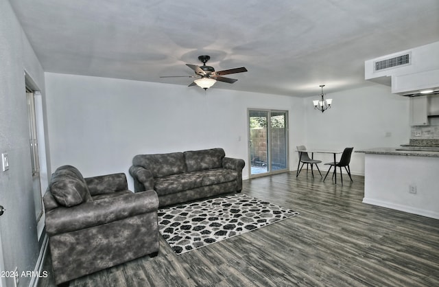 living room with hardwood / wood-style floors and ceiling fan with notable chandelier