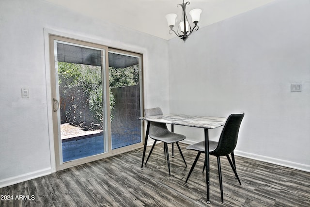 dining space with a notable chandelier and hardwood / wood-style floors