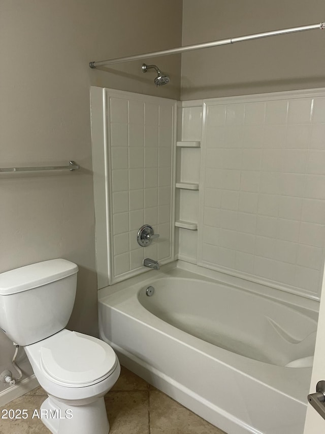 bathroom featuring toilet, tile patterned flooring, and tub / shower combination