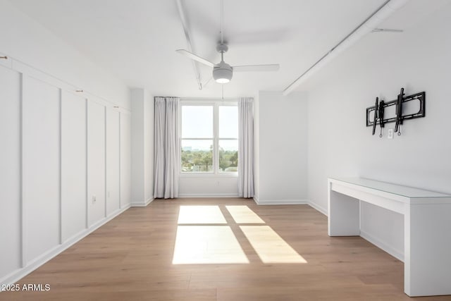 empty room featuring light wood-type flooring and ceiling fan