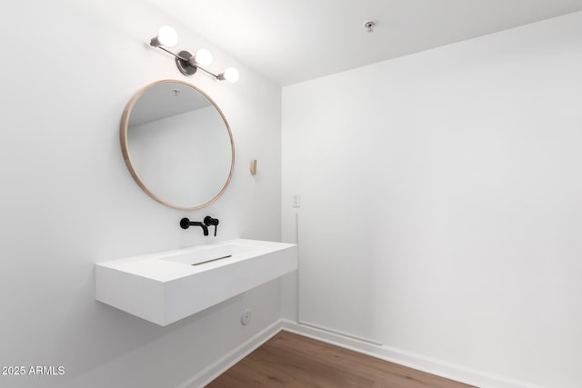 bathroom with hardwood / wood-style floors and sink