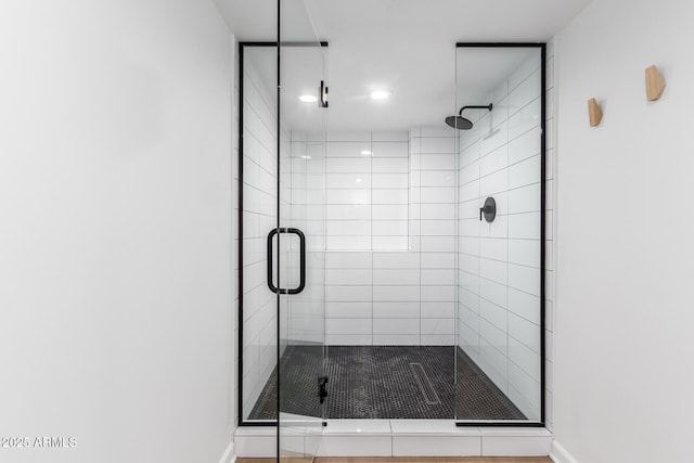 bathroom featuring a shower with shower door