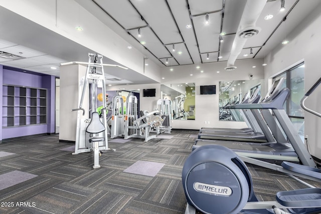 exercise room featuring dark colored carpet