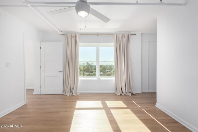 empty room featuring light hardwood / wood-style floors and ceiling fan