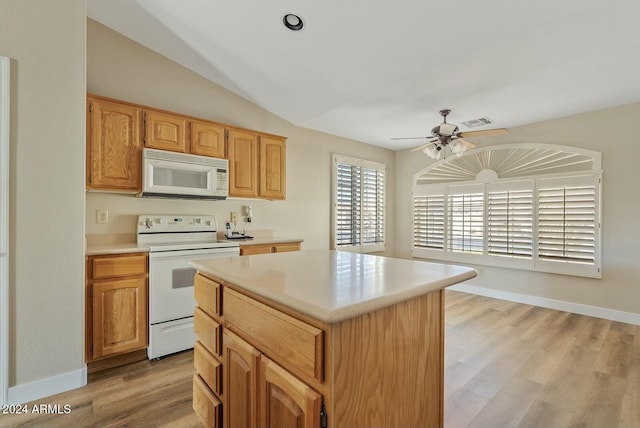 kitchen featuring ceiling fan, a center island, light hardwood / wood-style floors, and white appliances