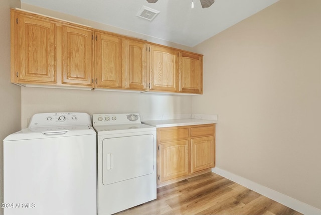 laundry area with washing machine and dryer, ceiling fan, cabinets, and light hardwood / wood-style floors