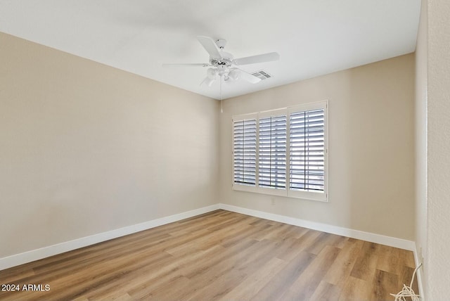 spare room featuring light hardwood / wood-style flooring and ceiling fan