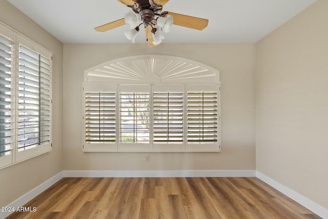 unfurnished room with hardwood / wood-style flooring and ceiling fan