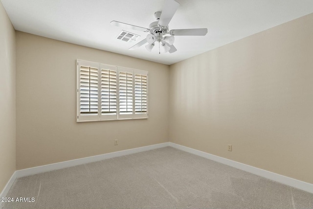 carpeted spare room with ceiling fan