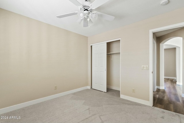 unfurnished bedroom featuring ceiling fan, a closet, and carpet floors