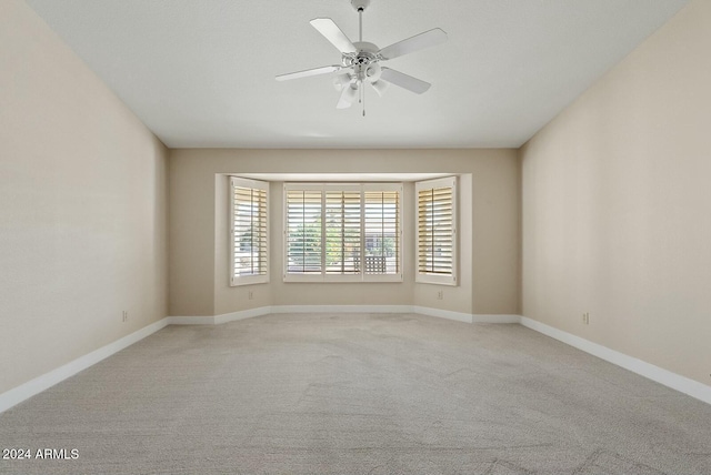 unfurnished room featuring ceiling fan and light colored carpet