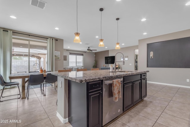 kitchen with dishwasher, a sink, light tile patterned flooring, light stone counters, and recessed lighting