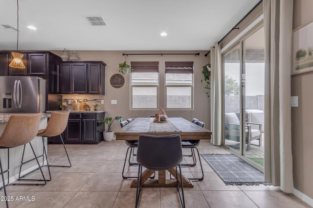 dining area with light tile patterned floors and recessed lighting