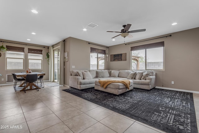 living area with light tile patterned floors, a ceiling fan, recessed lighting, and baseboards