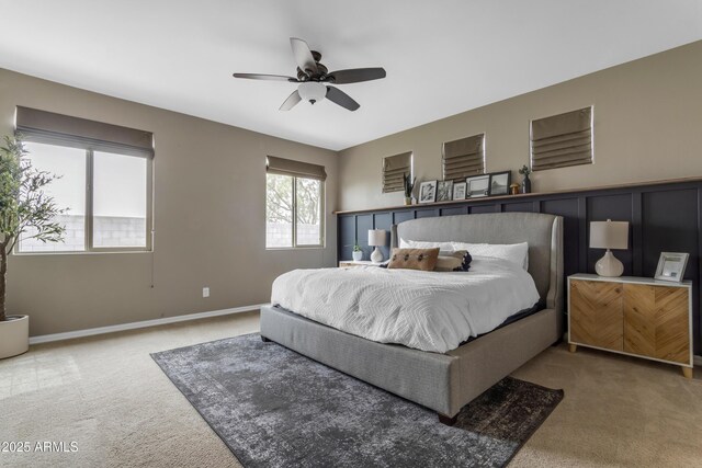 carpeted bedroom featuring baseboards and ceiling fan