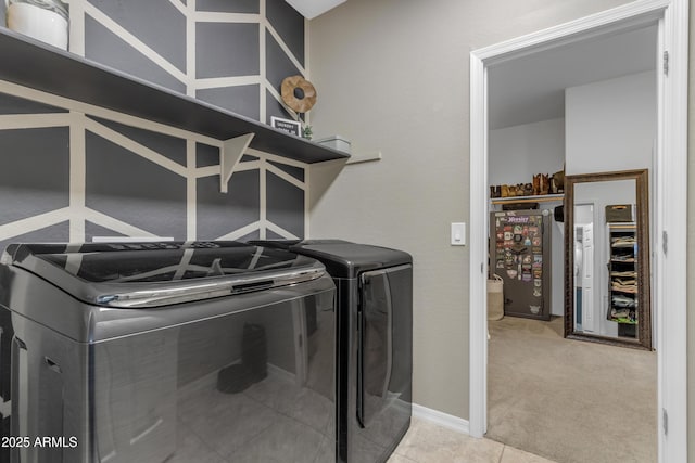 clothes washing area with washer and dryer and light colored carpet