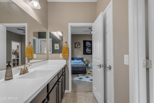 bathroom with tile patterned flooring, vanity, and ensuite bath