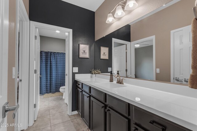 full bath with toilet, vanity, tile patterned flooring, and curtained shower