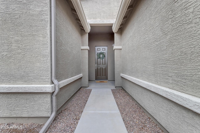 entrance to property with stucco siding