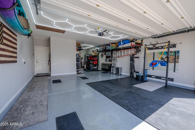 garage with baseboards and a garage door opener