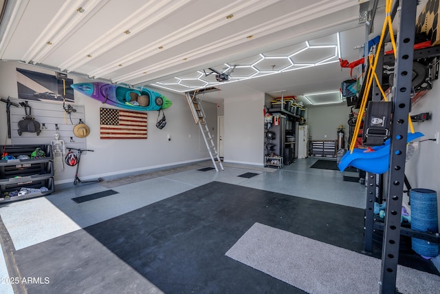 garage with baseboards and water heater