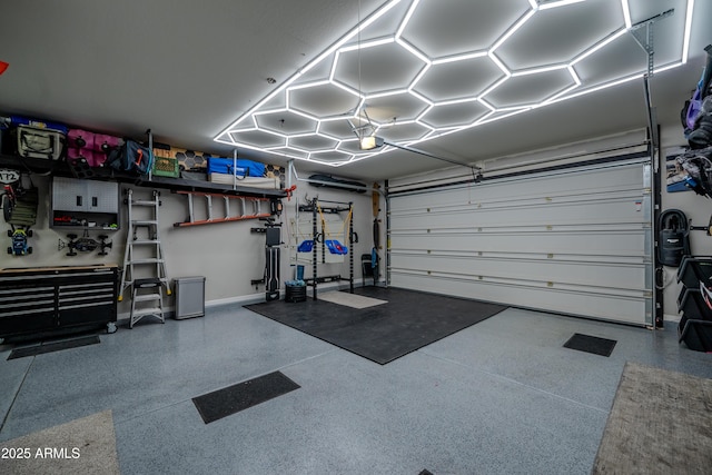 garage featuring a garage door opener and baseboards