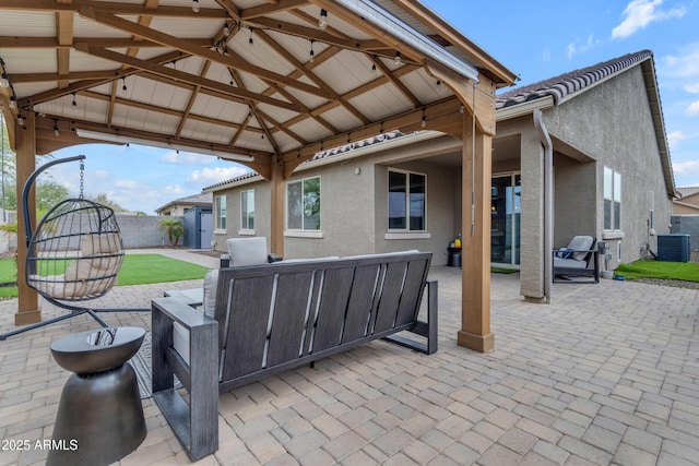 view of patio / terrace with a gazebo, a fenced backyard, and central AC
