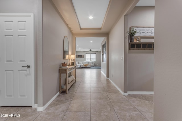corridor with light tile patterned floors, recessed lighting, and baseboards