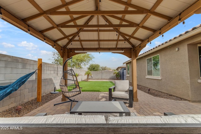 view of patio featuring a gazebo, a fenced backyard, and an outdoor living space