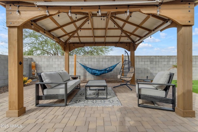 view of patio with a gazebo, a fenced backyard, and an outdoor hangout area