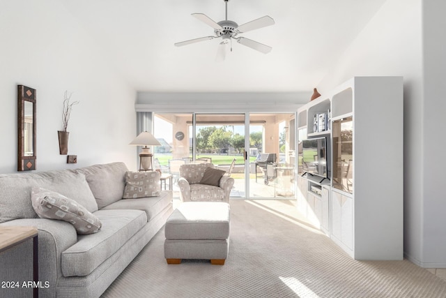 carpeted living room with ceiling fan