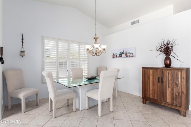 dining space featuring light tile patterned floors, lofted ceiling, and a notable chandelier