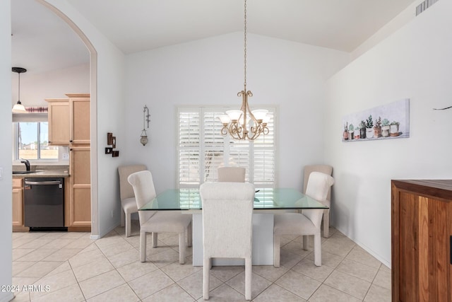 tiled dining space with lofted ceiling, sink, and an inviting chandelier