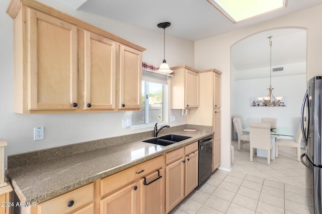 kitchen featuring pendant lighting, dishwasher, sink, and stainless steel refrigerator