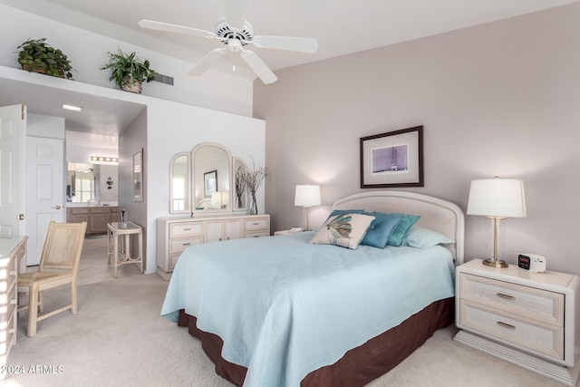 carpeted bedroom featuring ensuite bathroom and ceiling fan