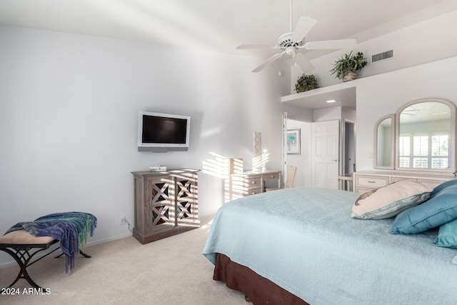 carpeted bedroom featuring ceiling fan and a towering ceiling