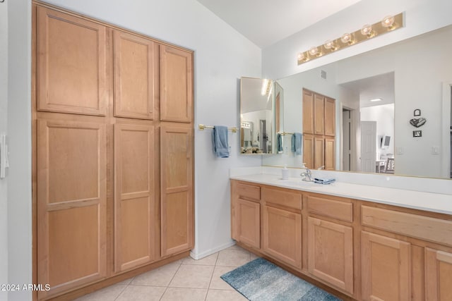 bathroom featuring tile patterned floors, vanity, and lofted ceiling