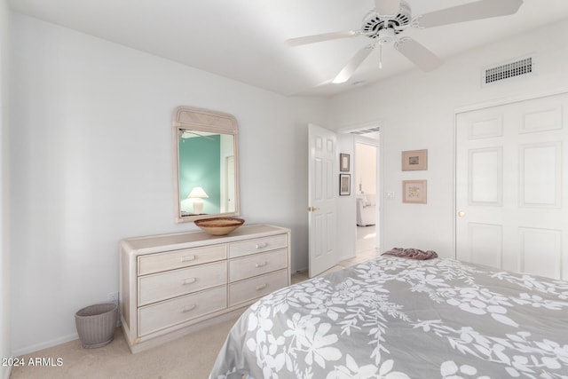 bedroom with ceiling fan and light carpet