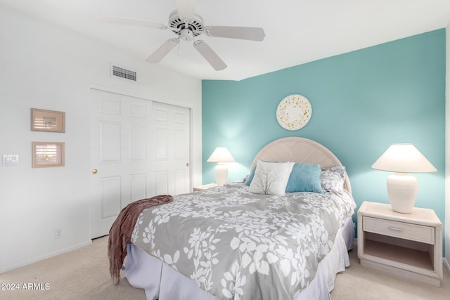 carpeted bedroom with a closet and ceiling fan